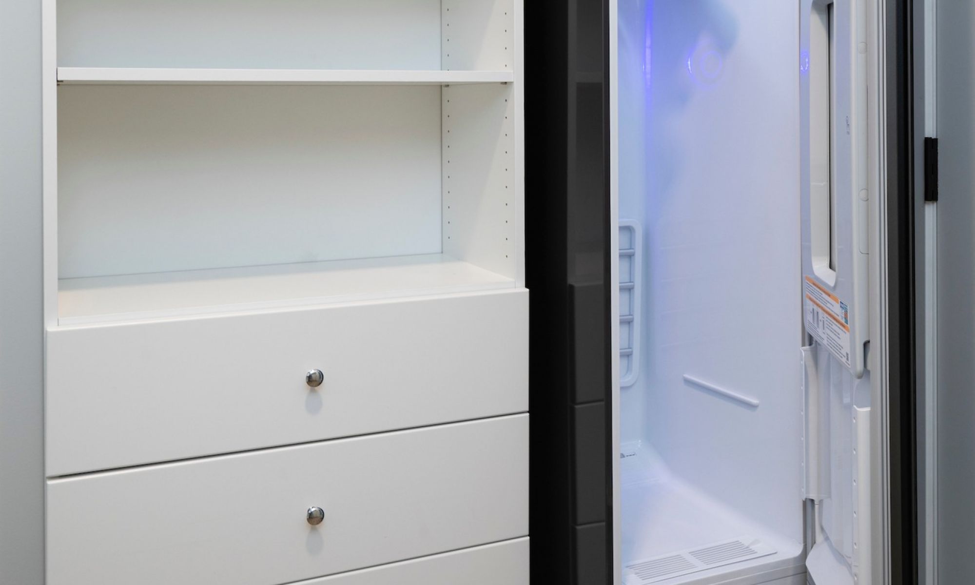 Close up of clothes storage and LG Styler Steam Closet in penthouse apartment