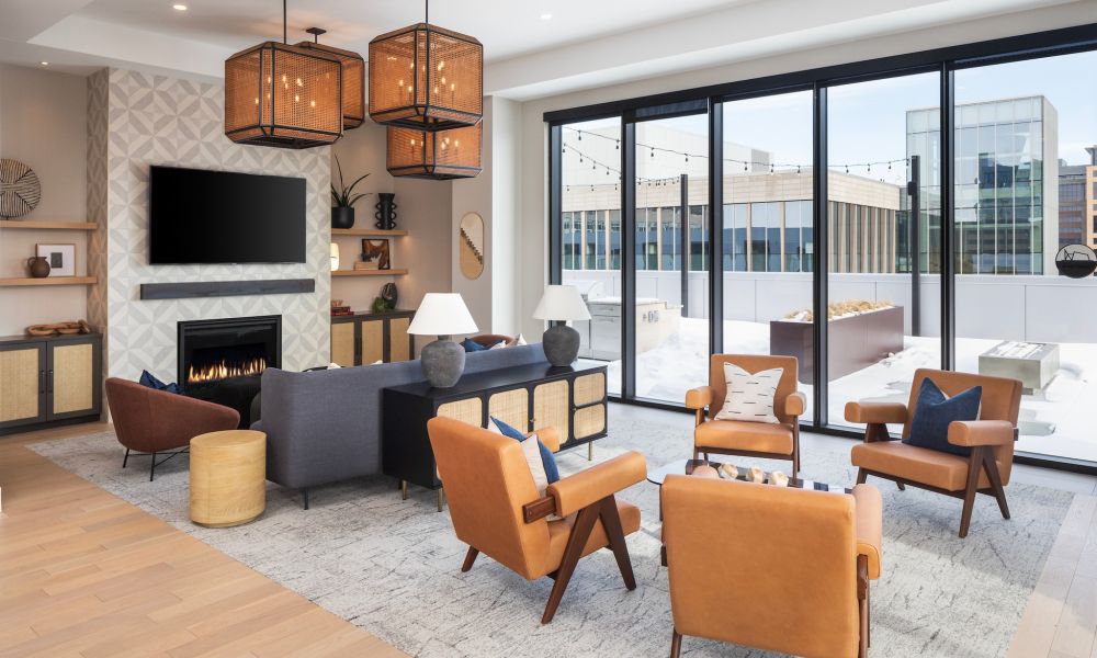 Moment apartments amenity lounge with comfortable seating and fireplace