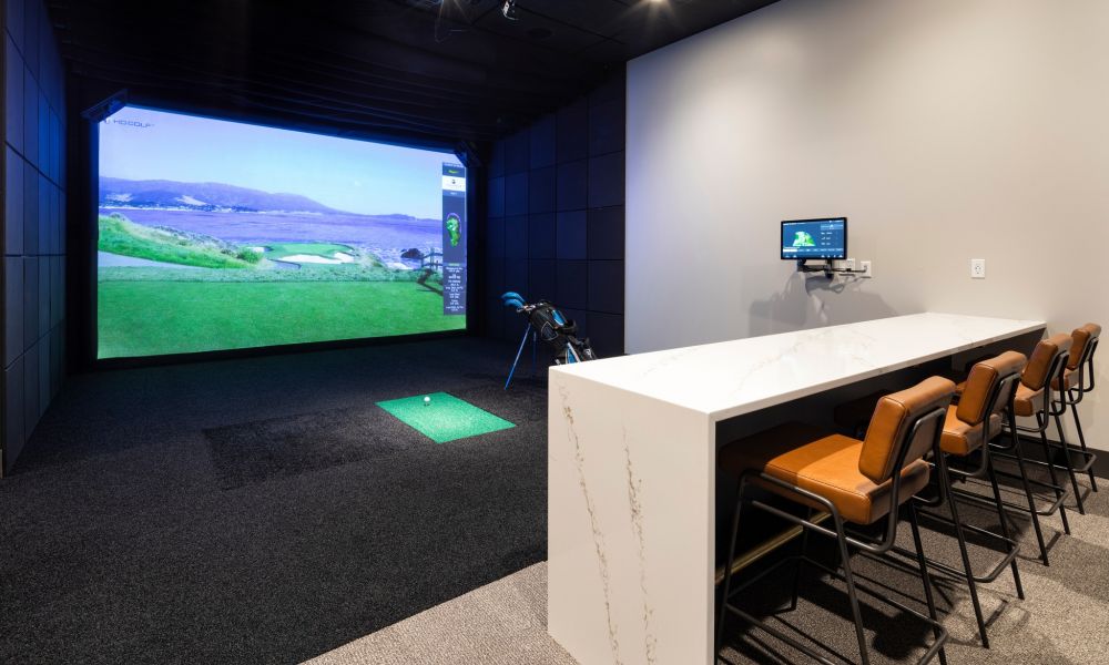 golf simulator and seating at Moment apartments