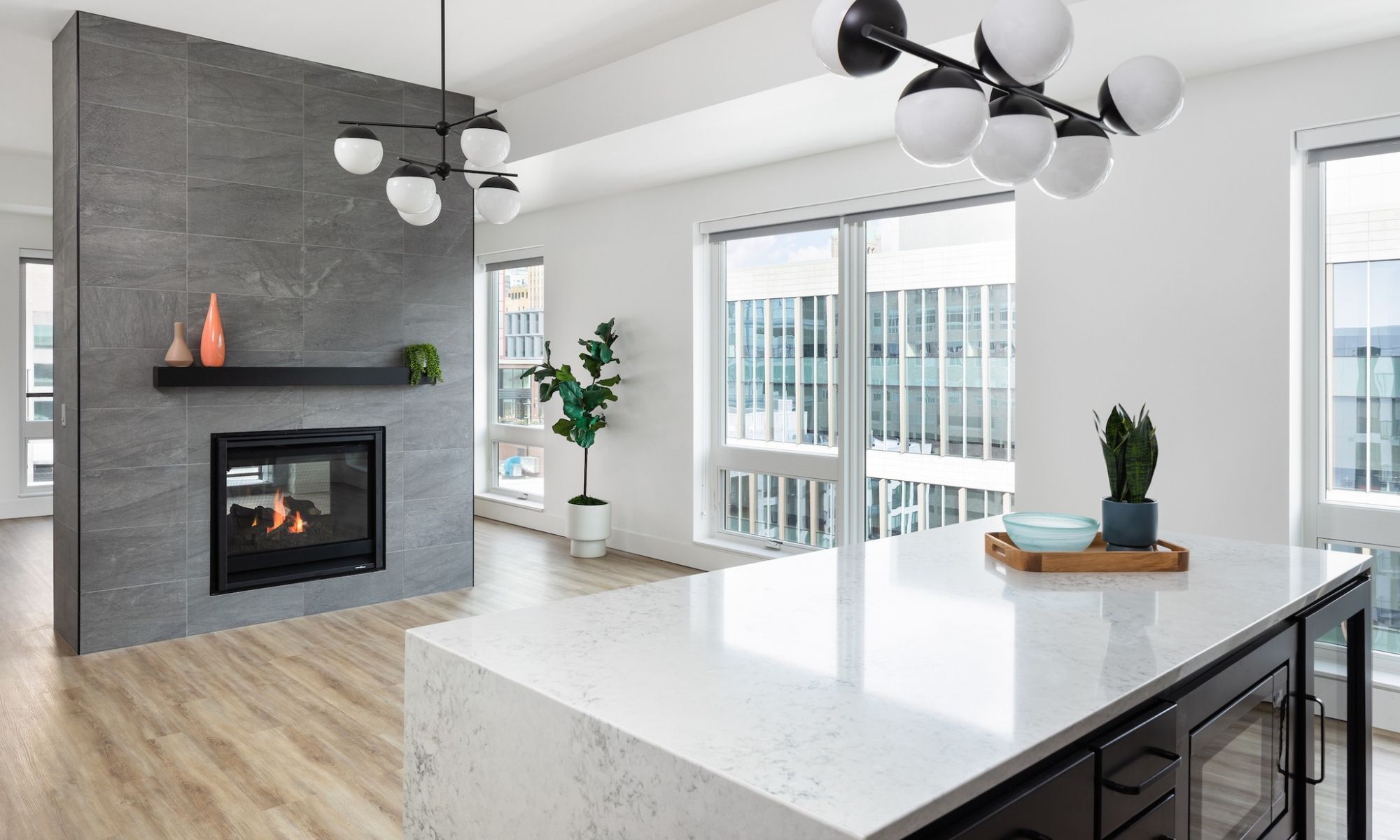Moment luxury apartments penthouse apartment showing double-sided fireplace and kitchen island